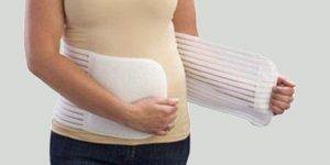 New mommy putting on a postpartum abdominal binder